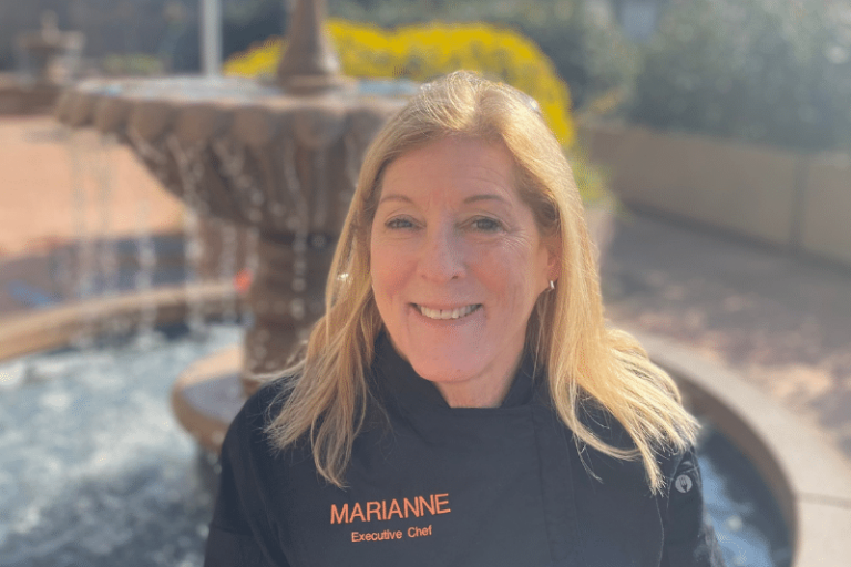 chef Marianne headshot in front of fountain