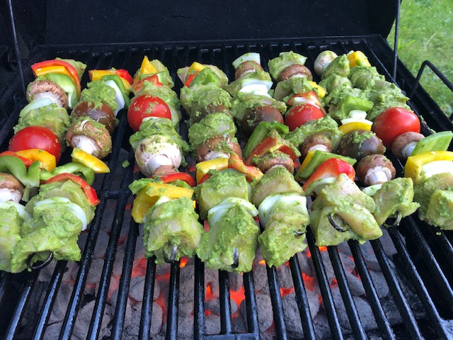 shashlik kebabs on the grill with meat, chicken, tomatoes, and peppers