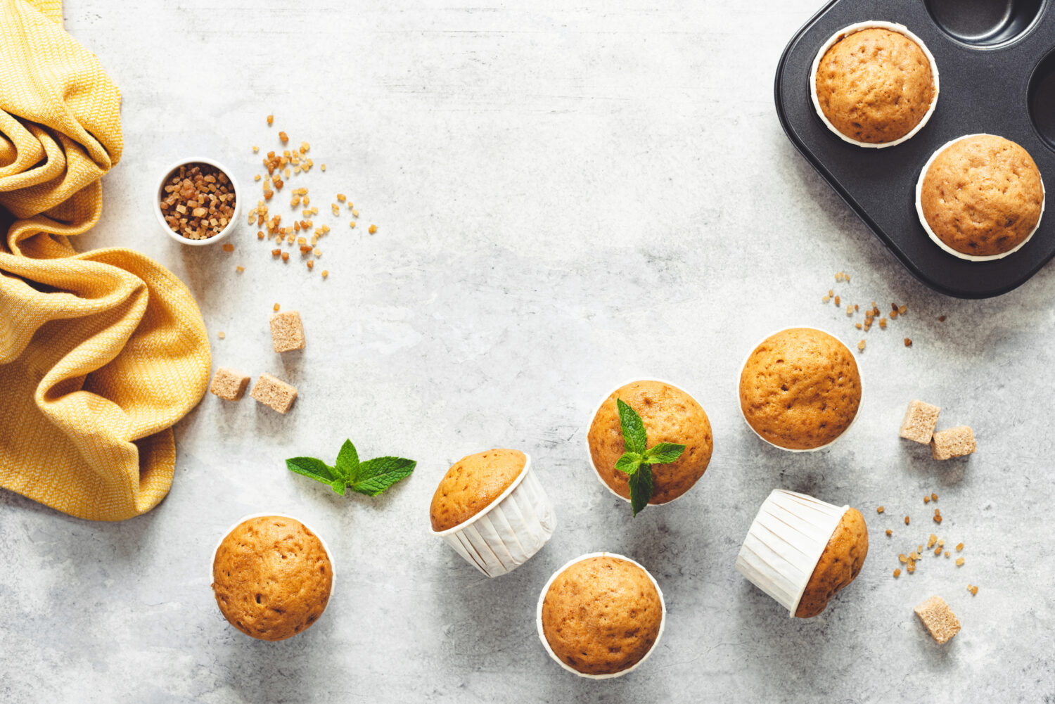 Vanilla Caramel Muffins In Paper Cups On Grey Concrete Background. Table Top View. Copy Space For Text