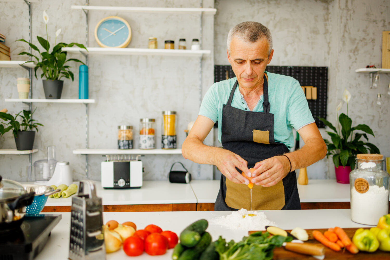 Man makes dough in kitchen at home