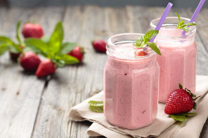 Fruit smoothie with mint leaves on wooden rustik table