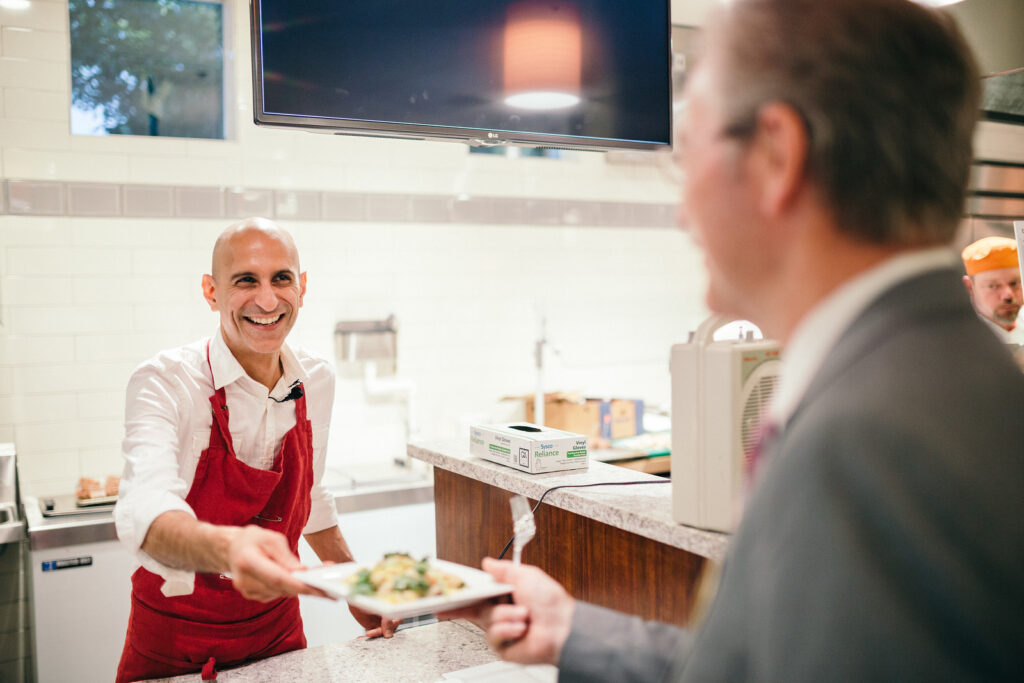 man employee smiling while serving food